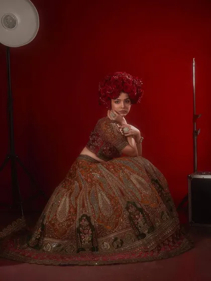A more avant-garde take on bridal, with a dramatic red floral headpiece and a stunning embroidered lehenga. We encourage students to find their unique bridal vision.