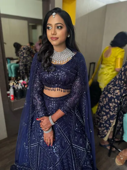 Dr. Akshara looking stunning in her full reception attire. The bold eye makeup is balanced with a neutral lip, and her diamond jewellery adds the perfect touch of sparkle.
