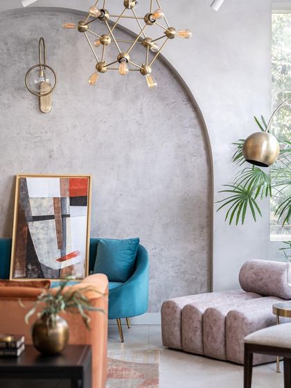 This retail space by BN Architects uses a curated mix of plush furniture, modern art, and industrial-style lighting to create a chic and inviting atmosphere.