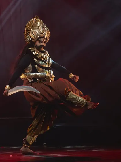 A fierce portrayal of an antagonist from the "KRISHNA" narrative. The elaborate costume, mask, and powerful stance bring the character to life with intimidating presence.