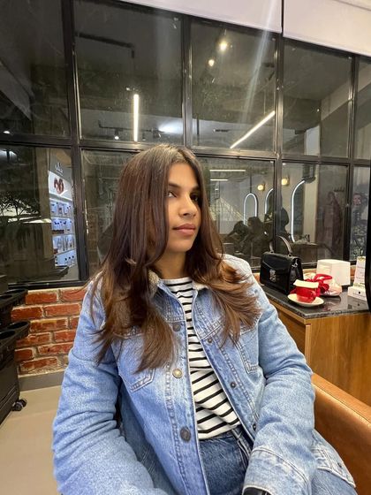 A client enjoying her fresh cut and subtle color, ready to take on the day with confidence.