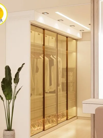 Another view of the luxurious walk-in closet with tinted glass doors, showcasing the high-quality finish and craftsmanship of our modular furniture.