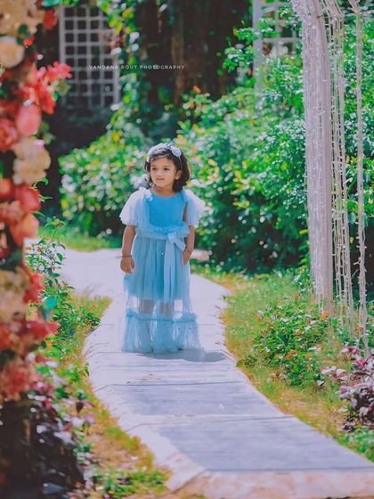 A real-life Cinderella story captured in a beautiful garden. The dreamy lighting and her elegant blue dress make this a truly magical photo.