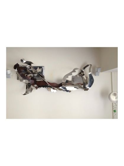 The full length of the 12-foot wall sculpture, which creates a powerful sense of horizontal movement.