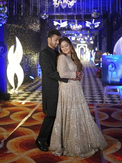 A full-length shot of the couple, showing the bride's gorgeous flowing lehenga, perfect for a night of dancing.
