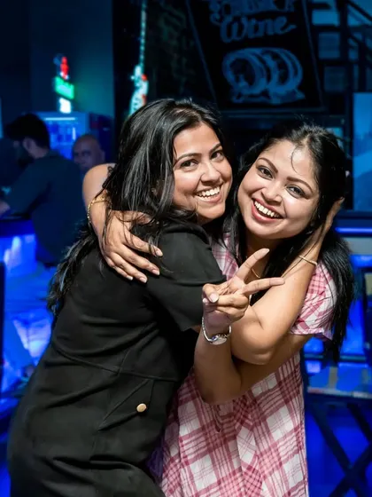 Two friends sharing a hug and a smile.