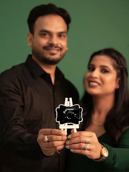 The first hello. This couple proudly displays their baby's sonogram picture, a beautiful and modern way to include their little one in the maternity shoot.