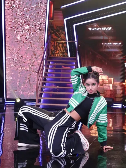A dynamic floor pose from one of our routines, demonstrating the athleticism and versatility required for a national competition.