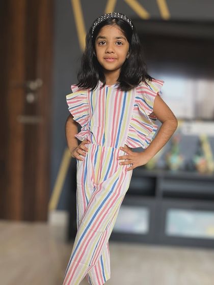 Rainbow stripes and endless smiles! This is the cutest jumpsuit for your little one, with playful cutouts, frilly sleeves, and all the comfort she needs for any adventure.