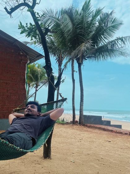 A traveler enjoying the peace and quiet of a beachside hammock in Gokarna.