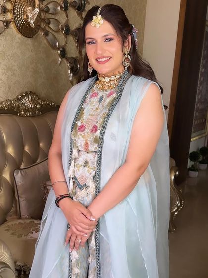 The full Mehendi look, showing the gorgeous pastel outfit and the fresh, dewy makeup that completes the style.