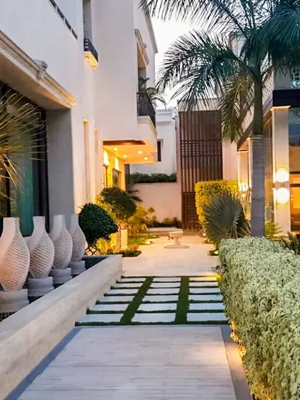 Our designs weave seamlessly with the environment. This landscaped walkway uses stone, greenery, and sculptural elements to create a path that is a work of art in itself.