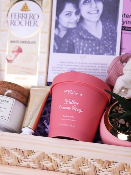 A close-up of the pampering products and chocolates inside the sister hamper, showing the thoughtful curation.