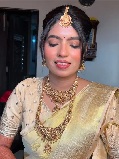 A close-up portrait showing the beautiful details of her temple jewellery and the soft, natural makeup.