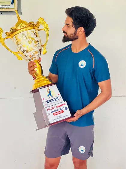 Another trophy added to our academy's cabinet. This player proudly holds the winner's trophy from the 4th Capt. Dharmpal Memorial Cricket tournament, a symbol of dedication and perseverance.