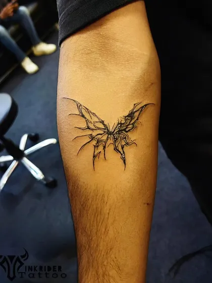 An abstract, edgy butterfly tattoo. This design uses sharp, graphic lines to give a modern and unique twist to a classic symbol.