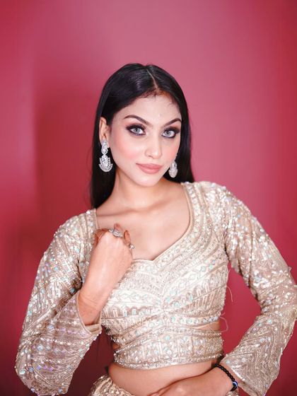 A close-up that captures the glamorous eye makeup and the sparkle of the outfit.