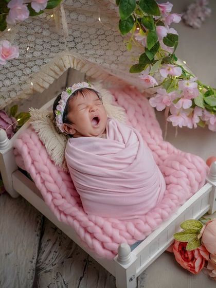 A tiny yawn in a floral wonderland. I love capturing these candid moments, like a sleepy yawn, amidst a beautifully styled set.
