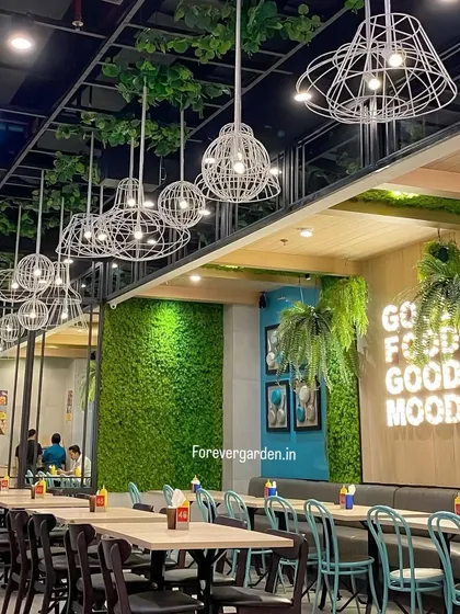 This restaurant uses a combination of our artificial moss wall and hanging plants to create a fresh, inviting atmosphere that reinforces its "Good Food Good Mood" theme.