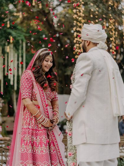 Another beautiful shot from the Varmala ceremony. The soft makeup enhances her features, making her look effortlessly beautiful.