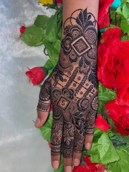 Another view of the personalized bridal mehendi, showing the intricate details and the hidden initial.