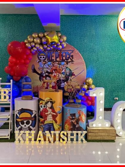 A pirate adventure with a One Piece-themed 10th birthday. The setup includes a character-filled backdrop, themed plinths, and a large light-up number '10'.