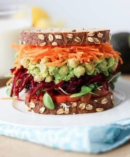 Who says healthy eating is just salads? This is my vegan chickpea salad sandwich, layered with shredded carrots, beetroot, and fresh greens on whole-grain bread. It's a satisfying and nutritious alternative to a classic chicken salad.
