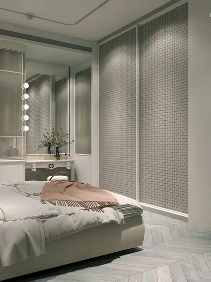 This neo-classical bedroom showcases luxury in pastels. Victorian-style wallpapers in tones of beige, ivory, and hints of dusty peach create a glamorous look, while chevron wood floors in a herringbone pattern add tasteful elegance and warmth.