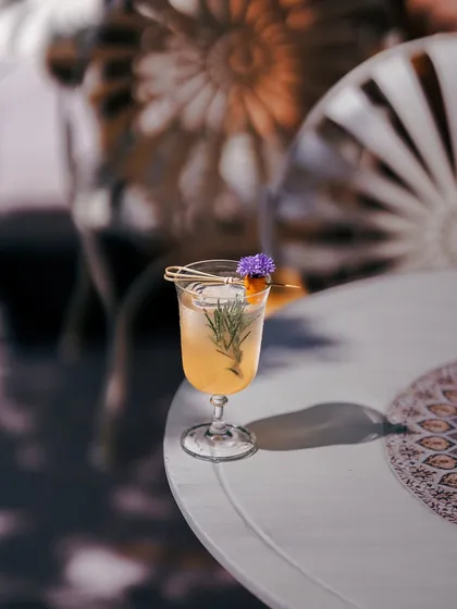 An artisanal cocktail inspired by the icy perches of Shambhala, crafted with hibiscus, gin, and gulkand for a vibrant, romantic flavor.
