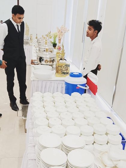 Our service staff setting up for a full-day catering event, ensuring all crockery and cutlery are perfectly arranged.