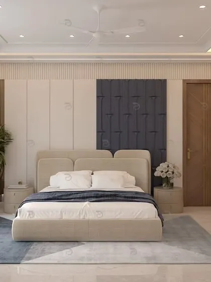 We create master bedrooms that feel like a personal sanctuary. This spacious room balances a neutral color palette with a bold blue upholstered headboard, a dedicated work-from-home corner, and elegant gold-accented wardrobes for a touch of luxury.