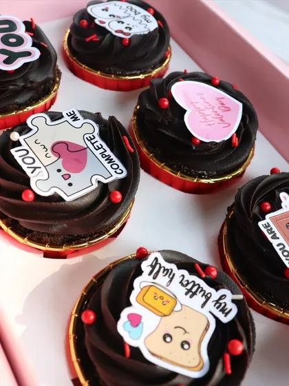 Another angle of my 'Love Notes' cupcakes, showing the rich chocolate frosting and cute designs in their pink gift box.