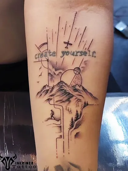 A beautiful collage-style tattoo for the travel lover. It combines mountains, a hiker, an airplane, and the quote "create yourself" into a single, inspiring piece.