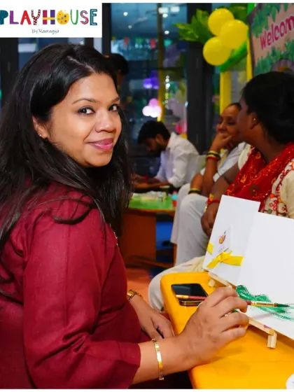 It's not just for the kids! I love it when parents join in on the creative fun. Here, a mother enjoys a quiet moment of painting during an art-themed party, making memories right alongside her child.