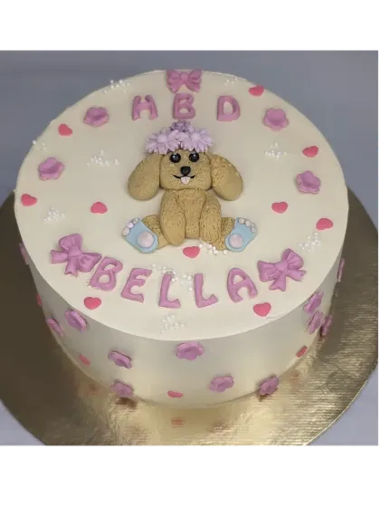 A sweet cake for a pet dog's birthday. This fresh mango cake is decorated with a cute fondant puppy, bows, and hearts.