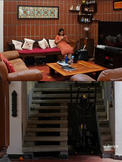 The living area and stone staircase of the Manjunath Residence, showcasing the home's multi-level design and use of natural materials.