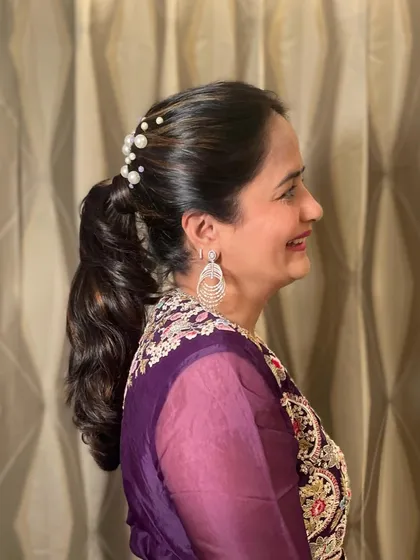 A profile shot of the elegant pearled ponytail.