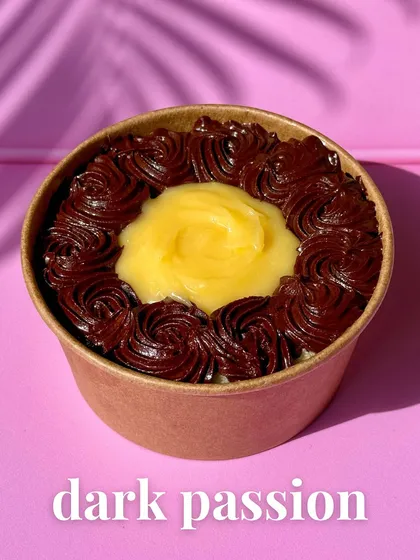 For the hardcore chocolate lovers, this is our Dark Passion Tub. It’s a single-serve pot of intensity, layering a silky 70% dark chocolate ganache with a tart passion fruit curd and fluffy chiffon sponge.