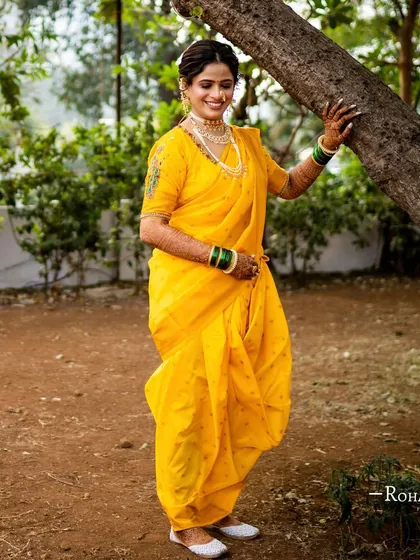 A full view of the yellow Navari saree. The makeup is kept fresh and minimal to balance the vibrant color and traditional drape of the outfit.