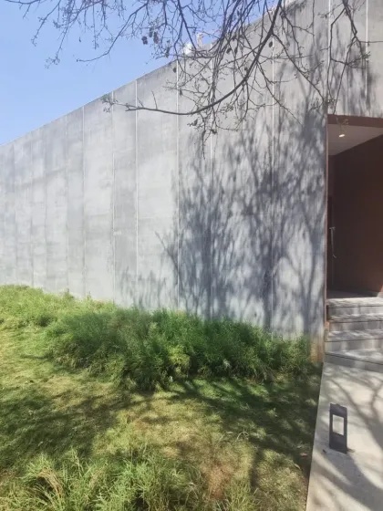 For this art gallery and marketing office in North Bangalore, I used a minimalist approach to the landscape. The gentle, grassy slope and the dramatic shadows cast by a nearby tree complement the clean lines of the concrete architecture.