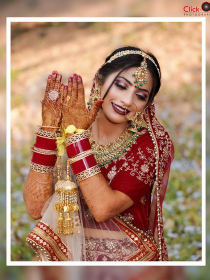 A happy bride showing off her mehndi-adorned hands, a perfect blend of a portrait and detail shot.