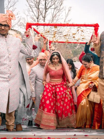 The bride's entry under the phoolon ki chadar, a beautiful and traditional moment. I capture the emotion on her face as she walks towards the mandap, held up by her loved ones.