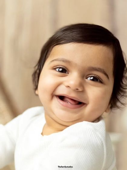 The purest smiles are what we aim for. This close-up shot captures the sheer happiness of a baby boy during his first birthday photoshoot.