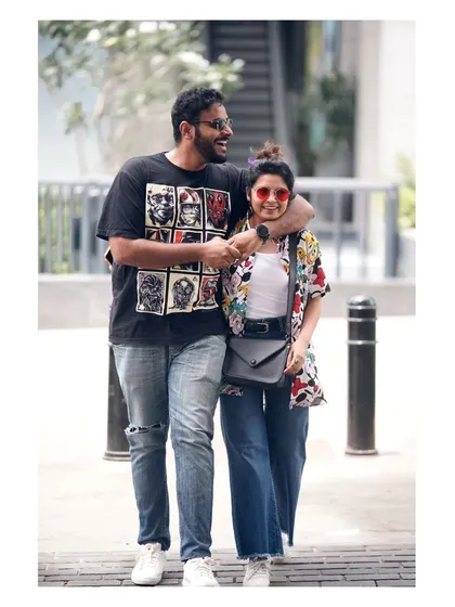 A candid, happy moment during an urban couple shoot in Bangalore. I believe the best portraits happen when you're just being yourselves, walking and laughing together on a familiar street.