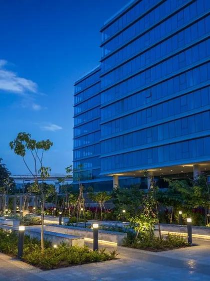 The Godrej Centre Development at dusk, where carefully designed landscape lighting enhances the integration of nature and architecture. This view highlights how our designs create a welcoming and serene environment that extends beyond the workday.