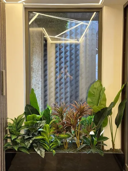 This planter is strategically placed to add greenery beneath a modern, geometric light fixture, creating a cohesive design story that balances hard lines with soft, natural elements.