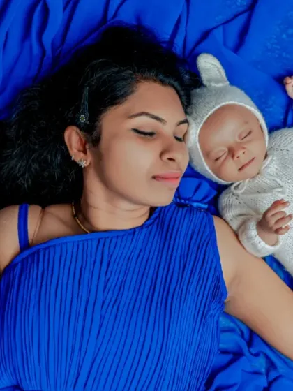Dreaming together. This overhead shot of a mother and her baby sleeping side by side creates a beautiful, artistic image of their peaceful connection.