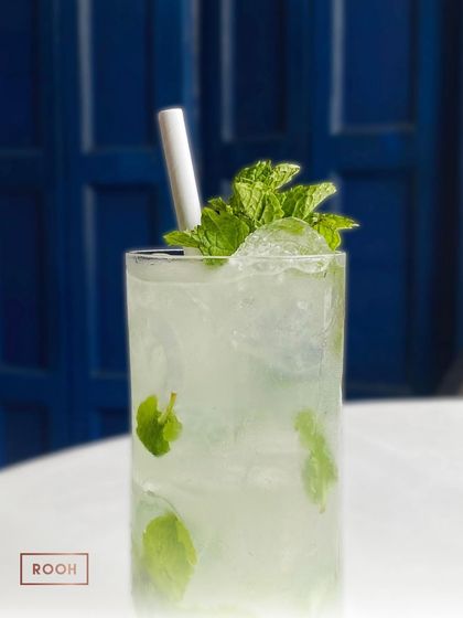 A close-up of our perfectly crafted Mojito, brimming with fresh mint and ice. It’s a timeless classic, done right.