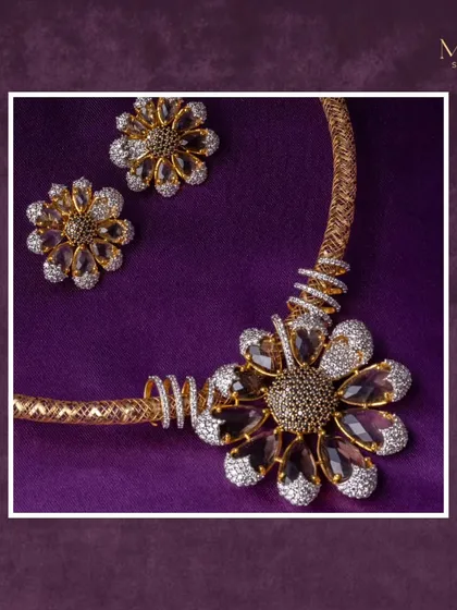 A statement floral necklace and earring set that embodies strength and elegance. The dark stones contrast beautifully with the sparkling diamonds, creating a bold and artistic piece.