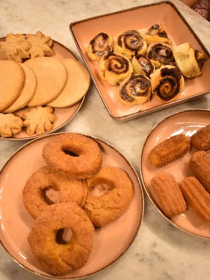 A delicious spread of all the cinnamon-themed treats a young student made in her private class: donuts, churros, cookies, and mini rolls.